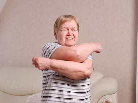 Elderly woman in the bedroom doing exercises.
