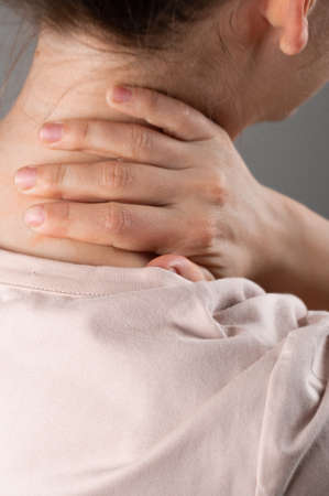 The woman's neck hurts. Place for inscription.の写真素材