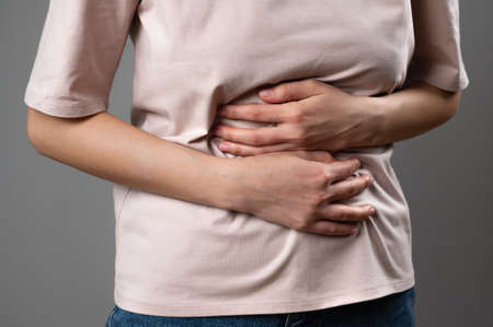 A woman with indigestion in the stomach.の写真素材