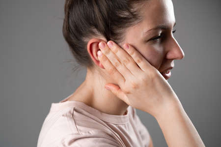 The woman has a sore ear.の写真素材