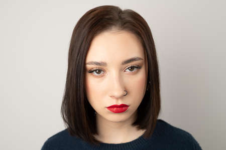 Portrait of a young brunette looking at the camera.の写真素材