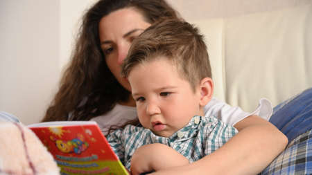 Young mother is engaged in the education of the child.の写真素材