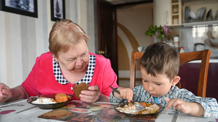 Caring grandmother with her grandson eat.の写真素材