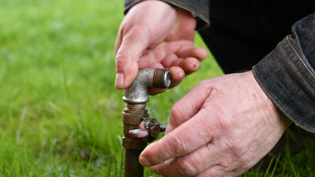 Water pipe for hose in grass.