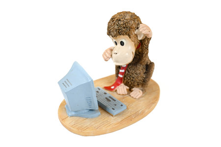 Monkey at the computer, statuette on an isolated background. High quality photoの写真素材