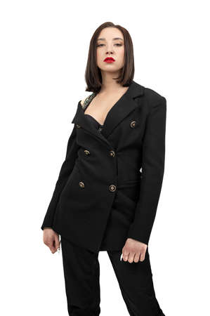 Portrait of a young brunette in a black suit. Looking at the camera on an isolated background.の写真素材