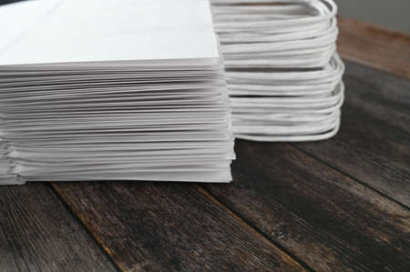 Stack of paper white package on wooden background. High quality photoの写真素材
