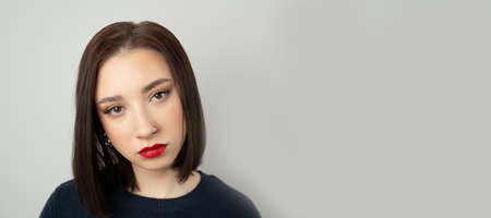 Portrait of a young brunette looking at the camera.の写真素材