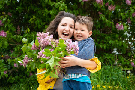 Happy mom with baby with flowers.の写真素材