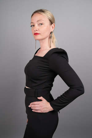Strict business woman on gray background.の写真素材