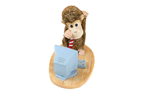 Monkey at the computer, statuette on an isolated backgroundの写真素材