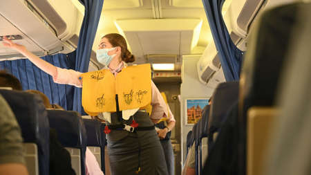 Minsk, Belarus - June 5, 2021: The stewardess shows the safety rules on the plane.のeditorial素材
