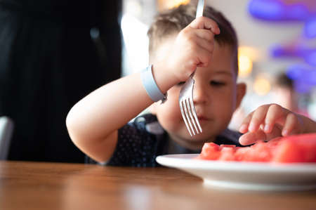 The child loves to eat watermelon.の写真素材