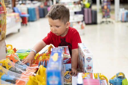 The child chooses a toy in the store.の写真素材