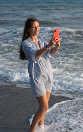 Young woman taking selfie on vacation.の写真素材