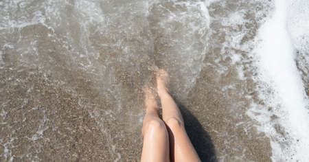 Female feet in the sea.の写真素材