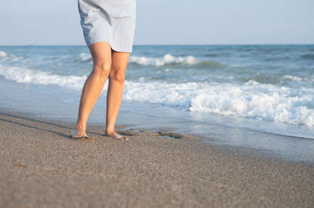 Young woman waiting by the sea.の写真素材