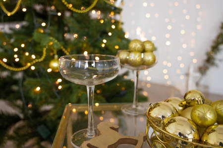 Christmas decoration in gold color with glasses of champagne.の写真素材