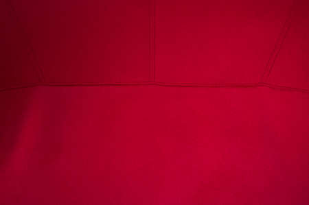 Finishing stitch, double seam, made with red threads in a product made of red fabricの写真素材