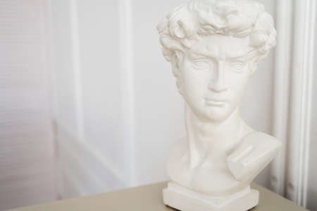 White gypsum statue of men head on light background with copy space.の写真素材