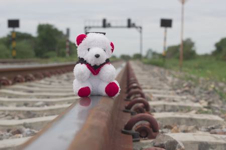 Toy teddy bear on the railroadの写真素材