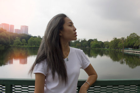 White haired woman in a public park it.の写真素材