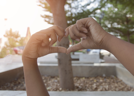 heart shape her hand's nature green backgroundの写真素材