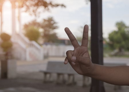 hand holding up the peace signの写真素材