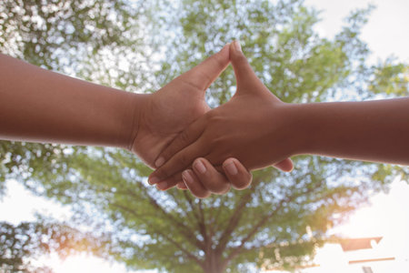 hands shake over nature background