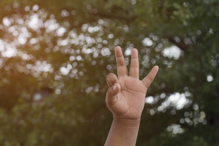 thumbs up on nature green backgroundの写真素材