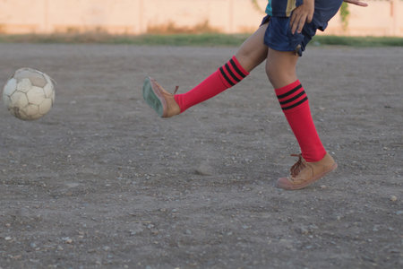 kids are playing soccer football for exercise in the evening.の写真素材