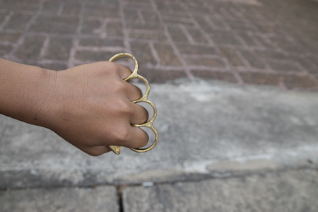 Hand man wearing brass knucklesの写真素材