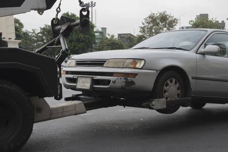police department tow truck delivers the damaged vehicleの写真素材