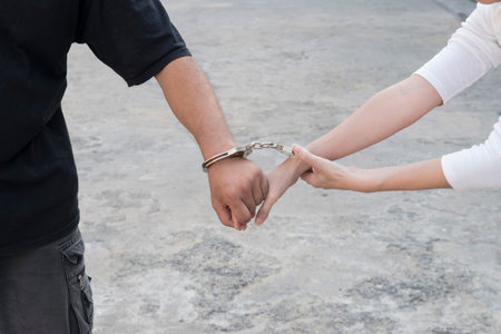 A man and woman's hands are handcuffed together. no freedom