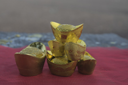 Chinese new year ornament--Stack of gold ingots on white background.の写真素材