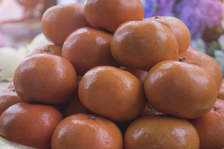 Oranges on the tray with pedestal. Use for make offerings and sacrifice to the spirits. Fruits for religious ceremony or holy festival,Thailand.の写真素材