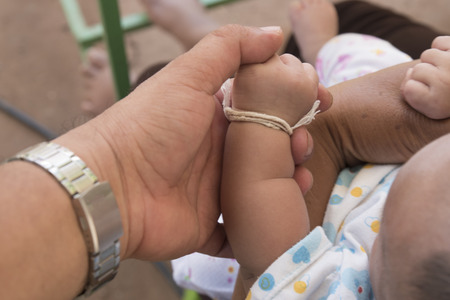 New born baby hand, man holding a baby hand,の写真素材