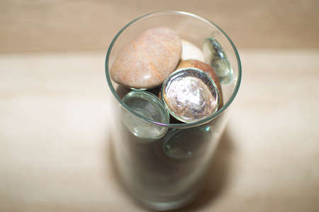 Decorative rocks, glass, and stone in a glass cylinder, shot from various angles and distancesの写真素材