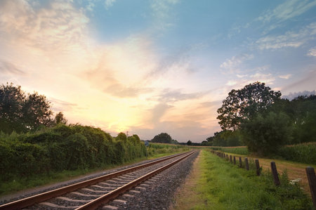 rail way tracks in a rural scene with nice pastel sunsetの写真素材