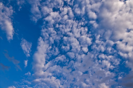 a lot of fluffy clouds in the sky with a little bit of blue sky visible  