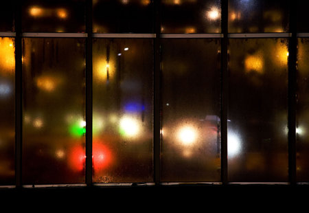 colorful lights showing trough some very dirty old glas window in iron frame