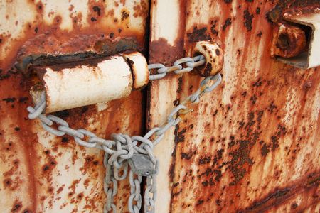 Old rusted doors chained and padlocked closeの写真素材