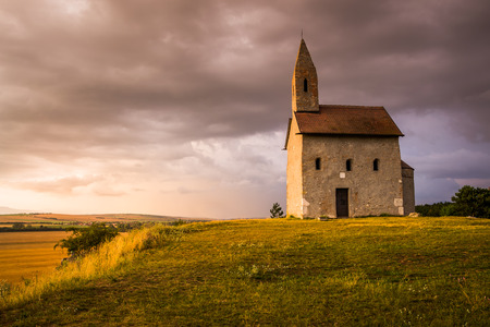 Old Roman Catholic Church of St. Michael the Archangel on the Hill at Sunset in Drazovce, Slovakiaの写真素材