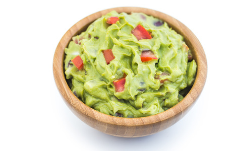 Guacamole in Wooden Bowl on White Backgroundの写真素材