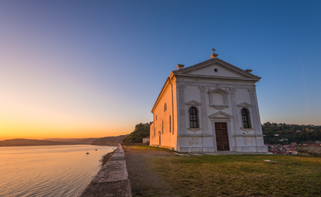 St. George's Church in Piran, Slovenia at Sunrise with Clear Blue Skyの写真素材