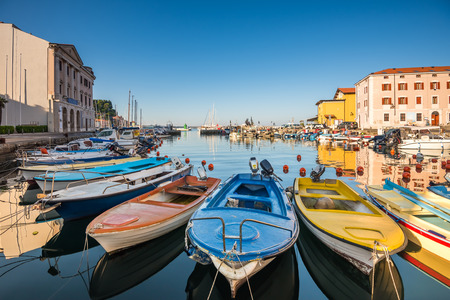 View of the Venetian Port of Piran, Slovenia with Boats in Foreground and Clear Blue Skyの写真素材