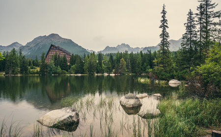 Strbske Pleso Mountain Lake in High Tatras Mountains, Slovakia with Rocks, Trees and Grass in...