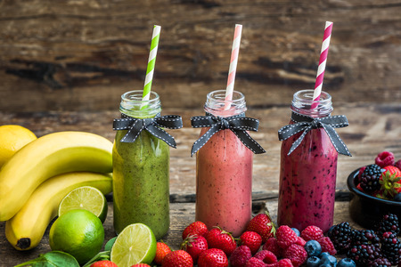 Healthy Fresh Smoothies and Fruit on Rustic Wooden Backgroundの写真素材