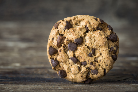 Closeup of Chocolate Chip Cookie on Rustic Wooden Table Backgroundの写真素材