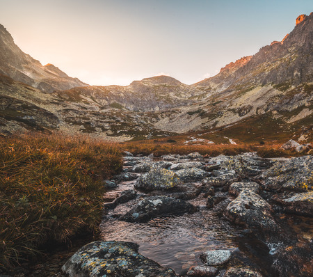 Creek in the Valley under the Mountain Peaks at Sunset. Velicka Valley, High Tatra, Slovakia.の写真素材